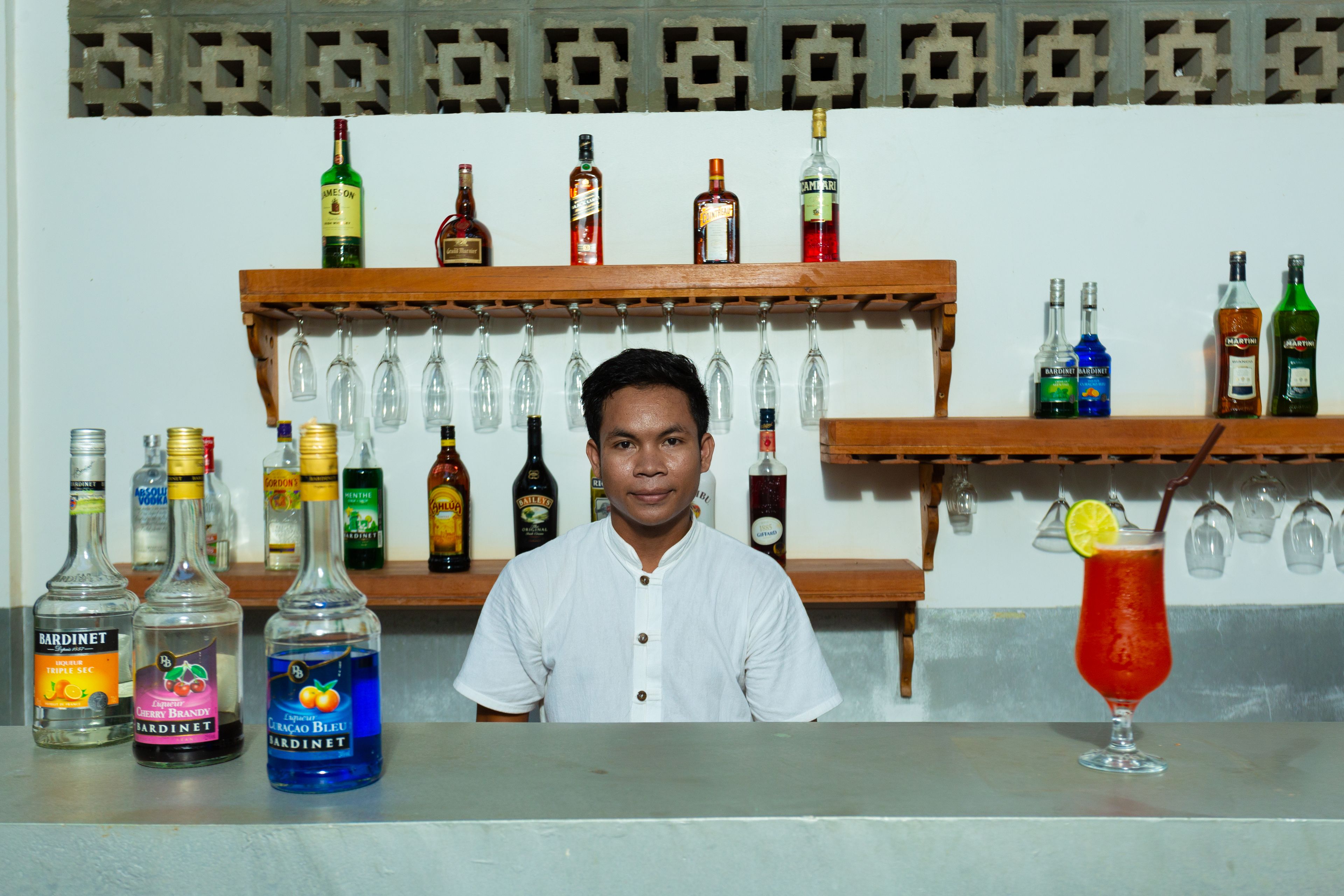 A bar area with various liquor bottles and glasses.