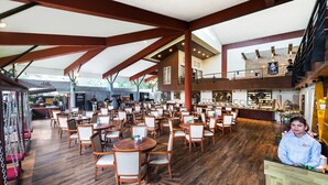 A spacious restaurant with high ceilings, wooden floors, and multiple dining areas. - Manas Lifestyle Resort Igatpuri (Igatpuri)