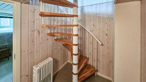 A spiral staircase with wooden steps and white railings, leading to an upper floor. - Nice home in Vesterøy with WiFi (Vesterøy)