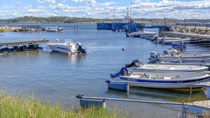 A marina with boats docked, a pier, and a distant shoreline. - Nice home in Vesterøy with WiFi (Vesterøy)