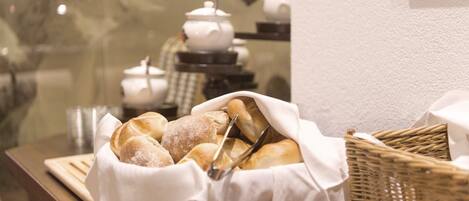 A basket of bread on a table with a white cloth.