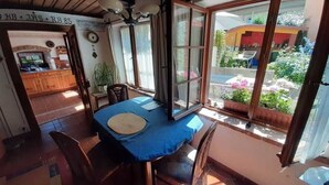 Ein Essbereich mit Tisch, Stühlen und Blick ins Freie.