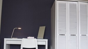 A room with a white desk, a chair, a laptop, a lamp, and a white wardrobe with louvered doors. - U-shuku Ar5 (Osaka)