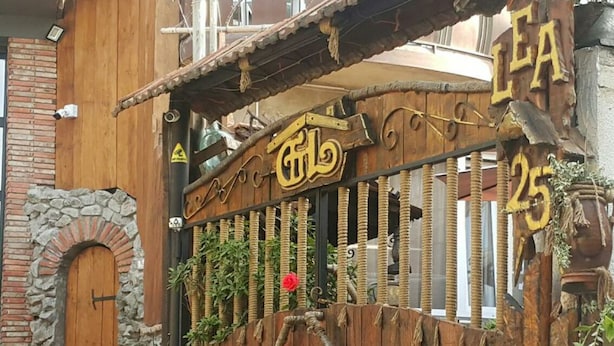 Una rústica puerta de madera con un letrero que dice "LEA 25".