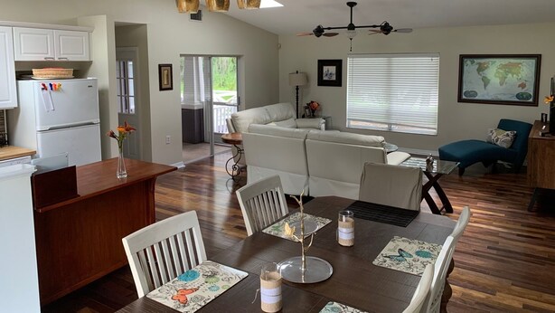 A modern living space with a dining area, kitchen, and seating area. - Lakefront VERY PRIVATE Guest House with Gorgeous Lake Views!  2-Bed, 2-Bath (Brandon)