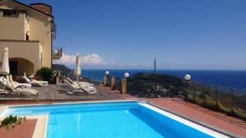 Seasonal outdoor pool, open 10:00 AM to 6:00 PM, pool umbrellas
