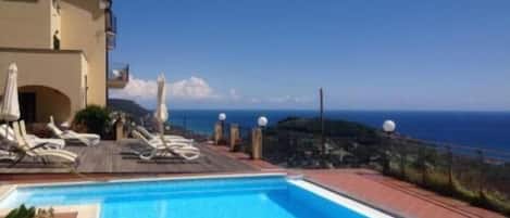 Seasonal outdoor pool, open 10:00 AM to 6:00 PM, pool umbrellas