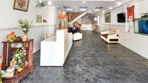A modern hotel lobby with a reception desk, seating area, and a staircase leading to upper floors. - O Dau Day Boutique Hotel (Ho Chi Minh City)