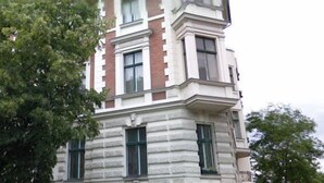 A multi-story building with a ground-floor cafe, large windows, and a visible entrance. - 364.Berlin (Berlin)