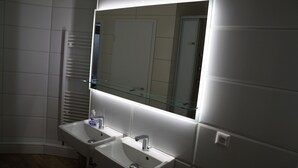 A modern bathroom with two sinks, a glass mirror, and a towel rack. - 364.Berlin (Berlin)