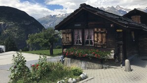 A rustic wooden building with a sign reading "Oberstollen." It features a traditional Alpine architectural style with a sloped roof and wooden shutters. - Apartment in Täsch / Zermatt for two persons (Täsch)