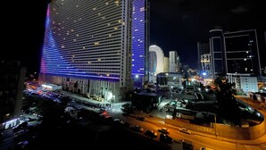 A high-rise hotel with a modern design, featuring a prominent facade with illuminated lines and a large entrance area. - Batumi Real Lux (Batumi)