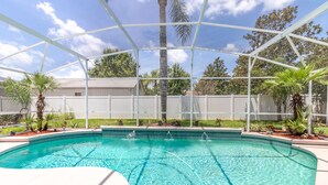 A swimming pool with a clear blue water, surrounded by a white fence and palm trees. - SEASONAL LOW RATES!!!Located in Disney's backyard- WITH PRIVATE POOL!!! (Clermont)