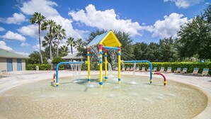 A water play area with a yellow and blue structure, surrounded by a sandy beach and lounge chairs. - SEASONAL LOW RATES!!!Located in Disney's backyard- WITH PRIVATE POOL!!! (Clermont)