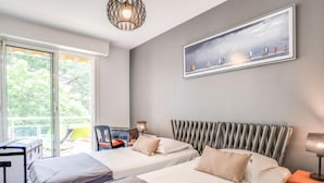 A hotel room with two beds, a desk, and a chair. - Port An Dro by Interhome (Carnac)