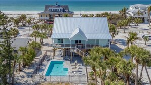 A beachfront property with a swimming pool, a covered patio, and a view of the ocean. - Family Tides: Beach Pool and Dock..This 5 Bedroom beach house has it all! (Placida)