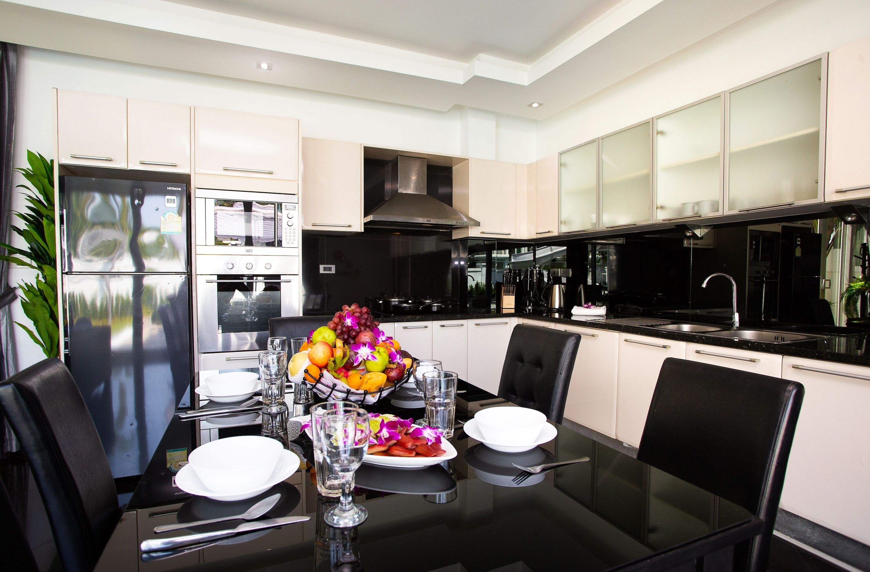 A modern kitchen with a dining area.