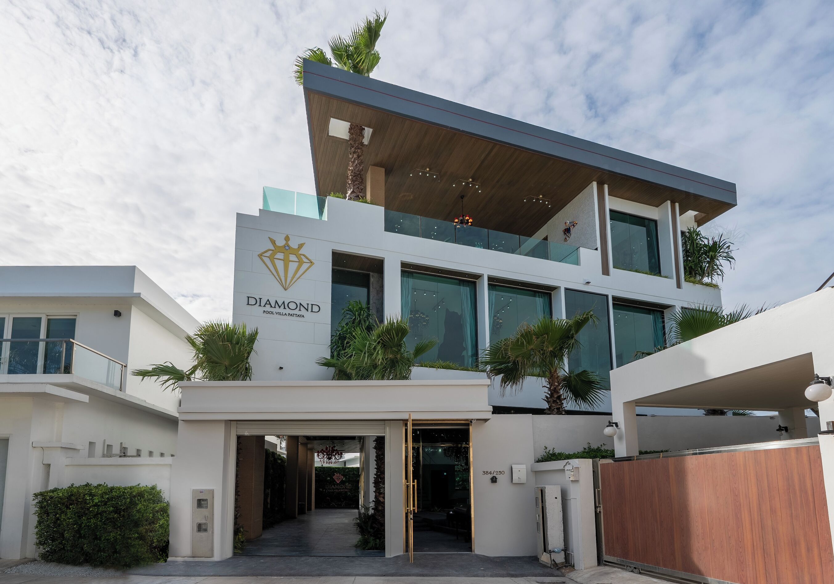 A modern multi-story hotel with a prominent logo, large windows, and a covered entrance.