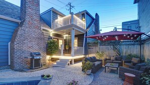A backyard with a barbecue grill, outdoor seating, a pool, and a covered patio area. - 1828 Cottage | Heated Pool in Private Garden | Sleeps 6 | Pets | On-Site Parking (Savannah)