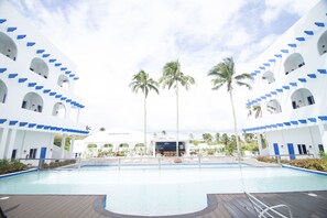 A pool area with a clear view of the resort's architecture, including multiple levels with balconies and a central building labeled "RESORT CENTER". - Brizo Hotel and Resort Tagaytay (Silang)