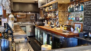 A bar area with a counter, various bottles, and a chalkboard menu listing specials. - The Lord Nelson Brewery Hotel (Millers Point)