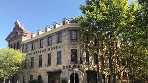 The exterior of the Ord Nelson Hotel, featuring a brick facade, large windows, and a sign indicating it is a brewery. - The Lord Nelson Brewery Hotel (Millers Point)
