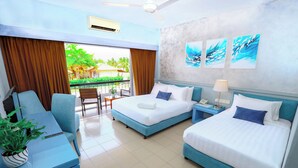A hotel room with two beds, a desk, a chair, a potted plant, and artwork on the wall. - Villea Morib (Banting)