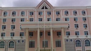 A pink building with the sign "ROYAL HOTEL" at the top. - Royal Hotel Luang Namtha ' Huang Ching' (Luang Namtha)