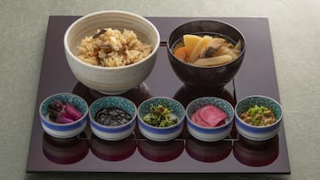 A traditional Japanese meal setup with rice, soup, and various side dishes on a tray.