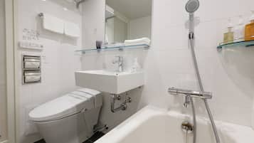 Un baño moderno con inodoro, lavamanos y bañera.