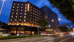 A modern hotel with a prominent 'FORZA' sign, multiple floors, and a well-lit entrance. - Hotel Forza Kanazawa (Kanazawa)