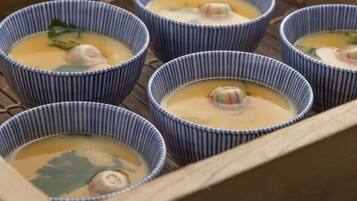 Six bowls of soup with dumplings, arranged on a tray.
