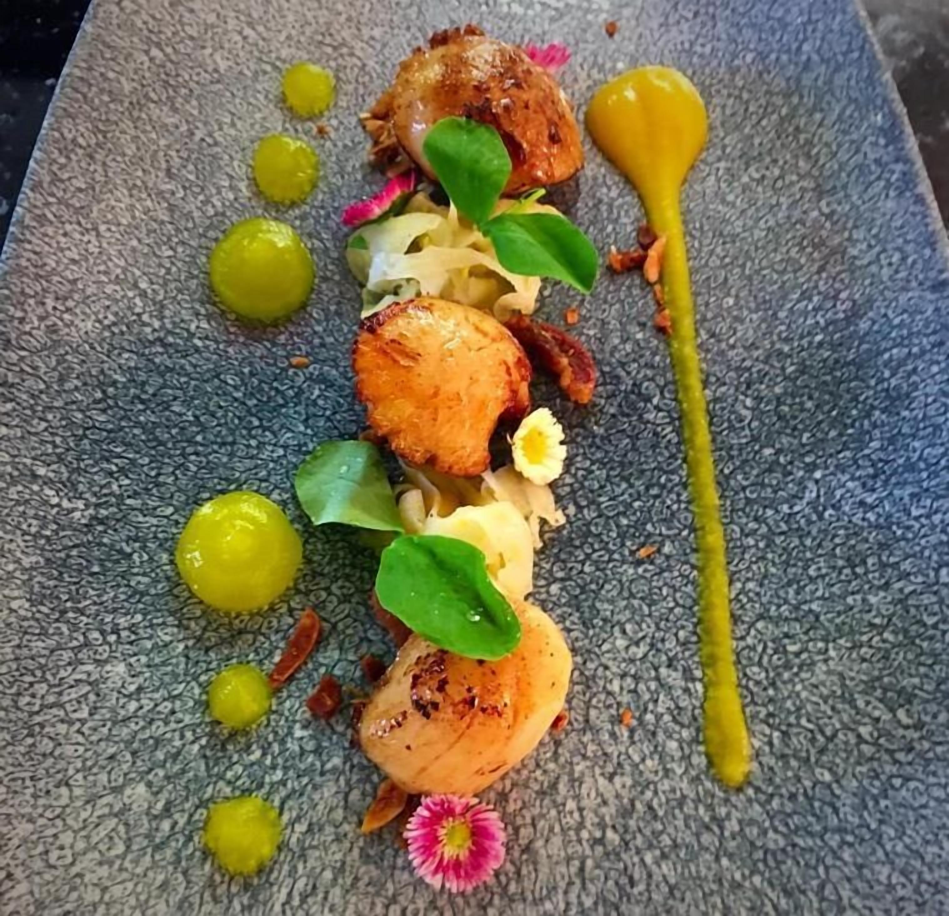 A plated dish with various garnishes and sauces.