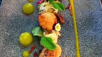 A plated dish with various garnishes and sauces.