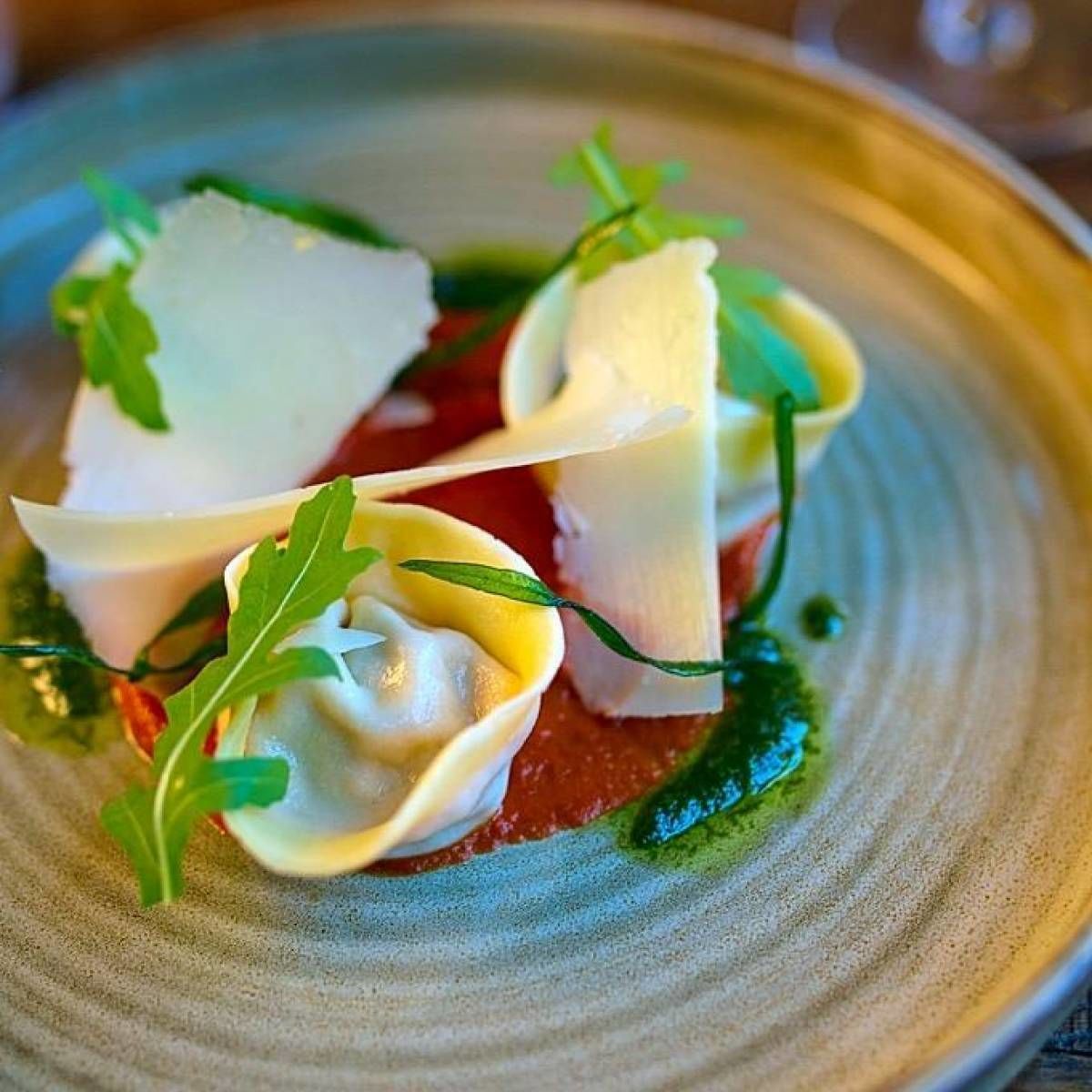 A plate of food with a creamy sauce, garnished with green leaves.