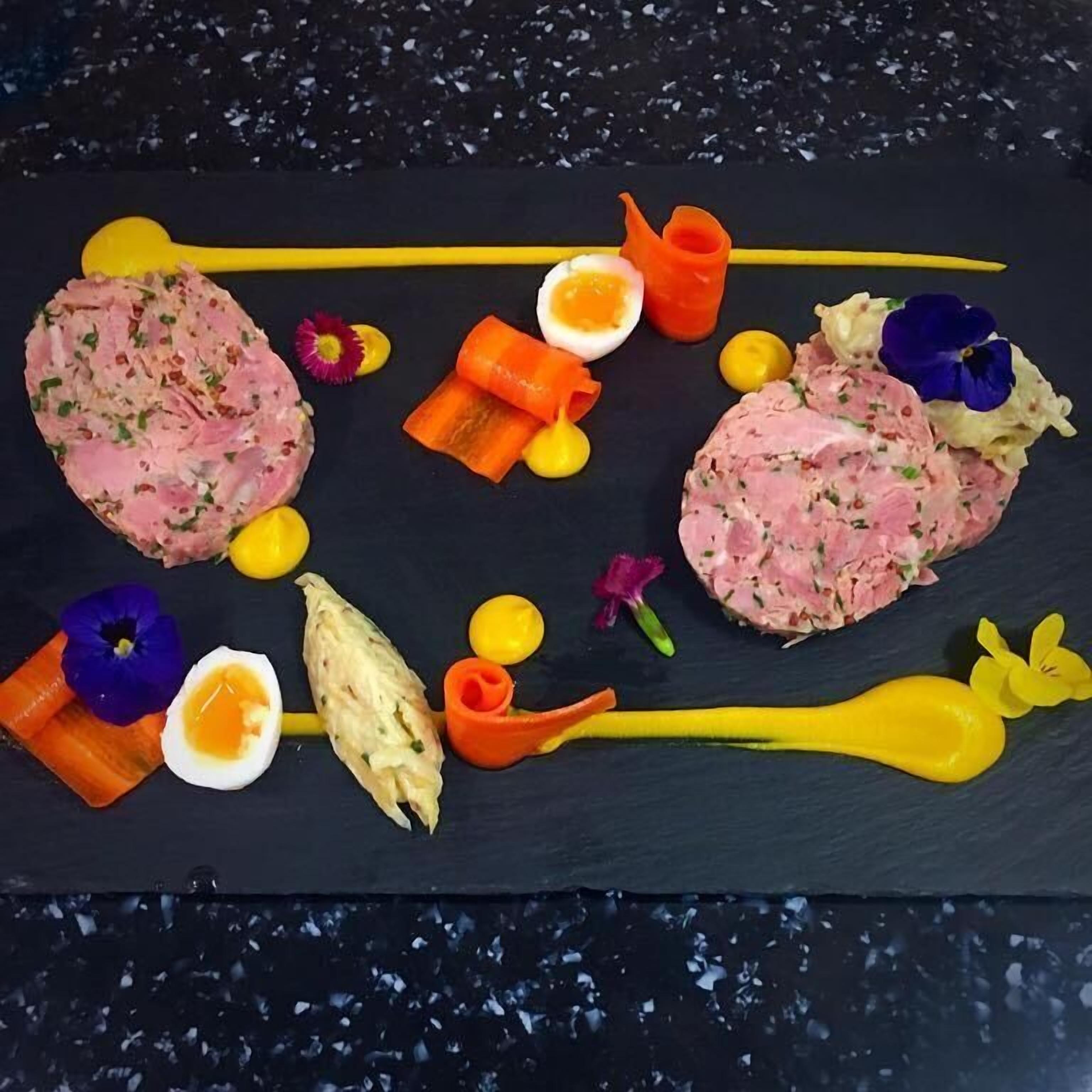 A black slate table with a variety of food items and garnishes.