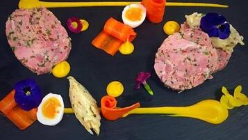 A black slate table with a variety of food items and garnishes.