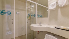 A bathroom with a glass-enclosed shower, a sink, and a toilet. - Sucha Hotel Wuhan Hankou Railway Station (Wuhan)