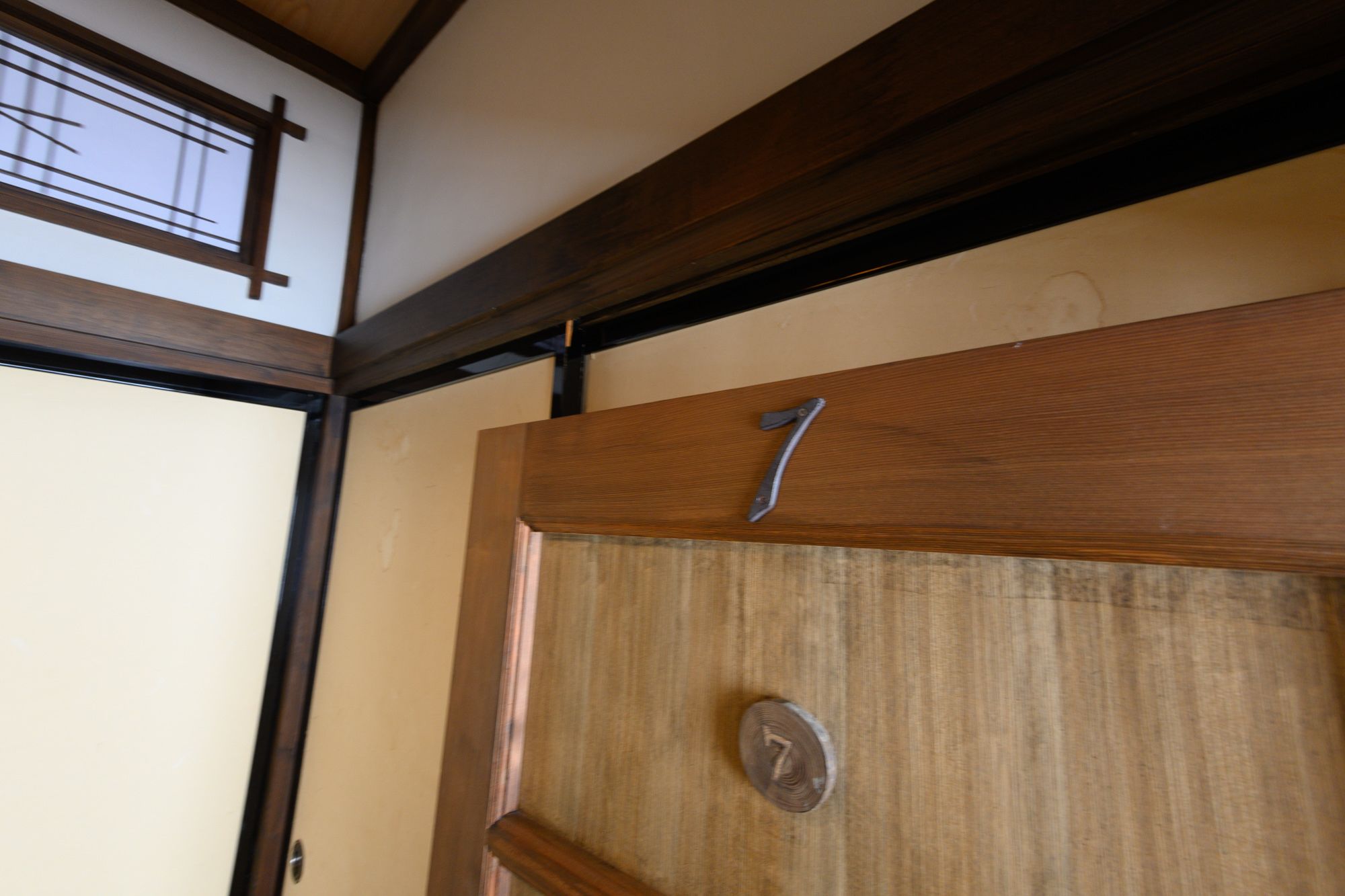 A wooden door with the number 7, indicating a room or apartment number.