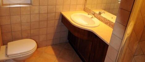 Un baño con inodoro, lavamanos y bañera.