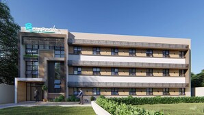 A modern hotel building with a sign reading "Bay Park Inn". It features multiple balconies with wooden railings and a flat roof design. - Baypark Inn (Calbayog)