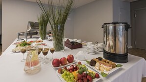A buffet table with various food items, a large stainless steel pot, and a vase with tall grasses. - ORO Dubingiai (Giraiciai)