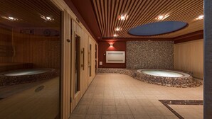 A spa room with two hot tubs, a wooden ceiling, and a tiled floor. - ORO Dubingiai (Giraiciai)