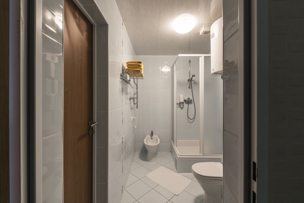 Un bagno compatto con toilette, bidet e zona doccia.