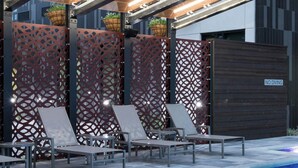 A pool area with lounge chairs, a wooden fence, and a sign indicating no diving. - Courtyard by Marriott Houston Heights/I-10 (Houston)