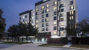 A multi-story hotel with a modern design, featuring a prominent 'Courtyard by Marriott' sign. - Courtyard by Marriott Houston Heights/I-10 (Houston)