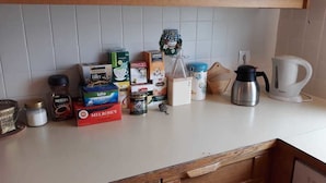 A kitchen counter with various food items and kitchen appliances. - Gljúfraborg (Fjardabyggd)
