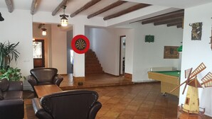 A spacious living area with a billiards table, a dartboard, and a windmill decoration. - BonDia (Rasnov)