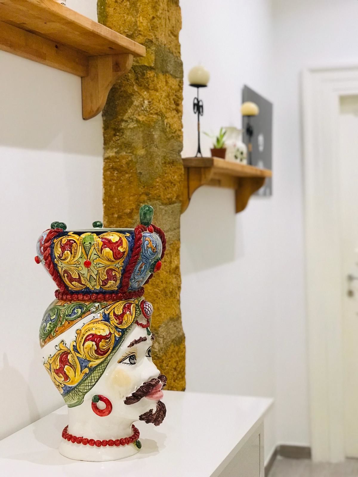 A decorative ceramic piece with a colorful design on a white surface.