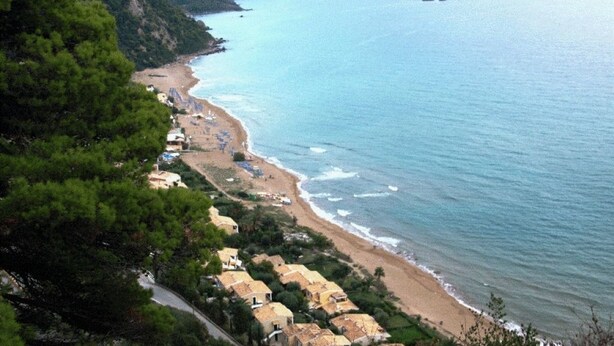 A coastal area with a beach, houses, and a road. - Corfu Island Apartment 40 (Corfu)